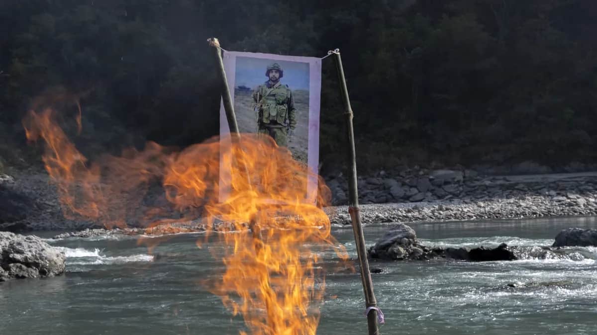 An image of a Nepali killed in Ukraine is burned instead of his body, which was not returned to his family, during a funeral service on the banks of the Kaligandaki River, Nepal, 19 January 2024. EPA-EFE / NARENDRA SHRESTHA