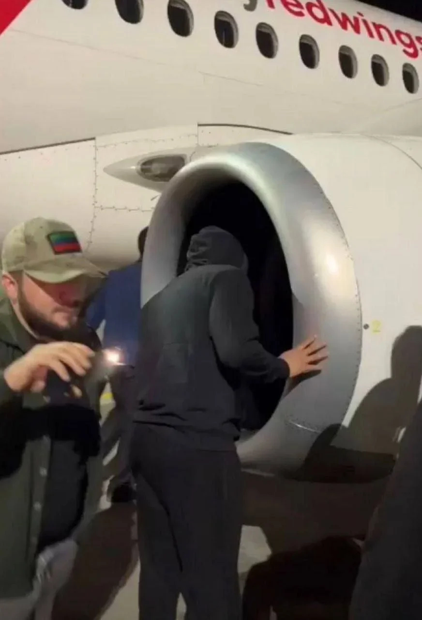 Rioter looking into the aircraft engine. Photo: social media