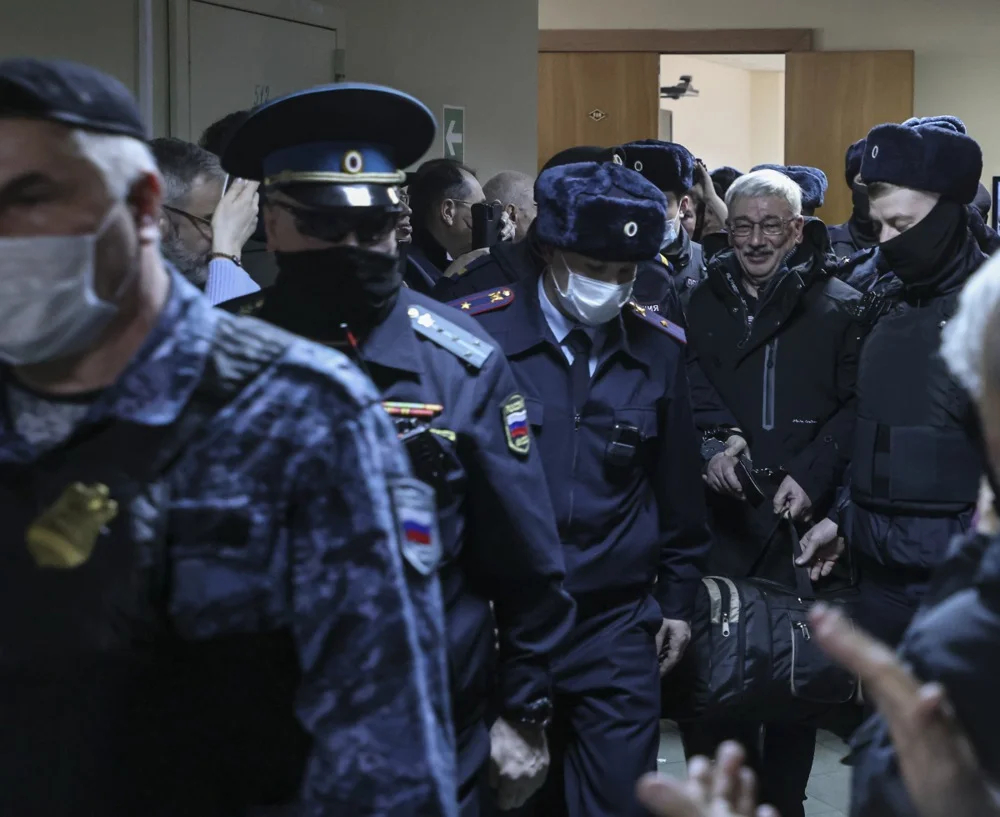 Policemen escort Orlov from a Moscow court after his verdict was announced, 27 February 2024. Photo: EPA-EFE / SERGEI ILNITSKY