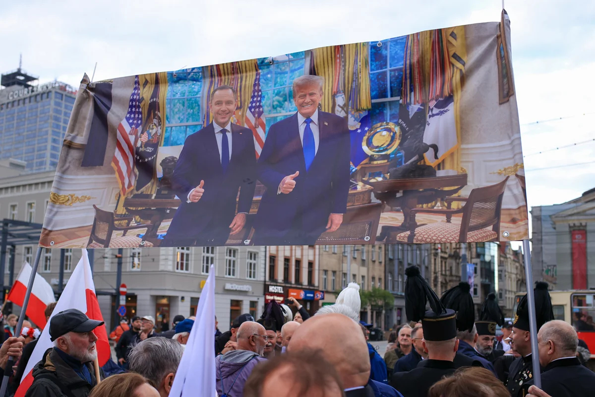 Сторонники Кароля Навроцкого держат баннер с фотографией его встречи с Дональдом Трампом во время предвыборного митинга в Катовице, Польша, 29 мая 2025 года. Фото: Jarek Praszkiewicz / EPA-EFE
