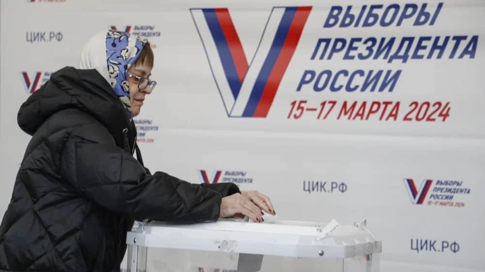 A woman casts her ballot at a polling station in Moscow on Friday. EPA-EFE/MAXIM SHIPENKOV