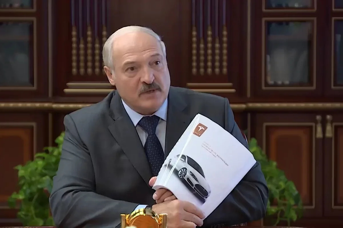 Alexander Lukashenko holds a Tesla manual. Photo: YouTube