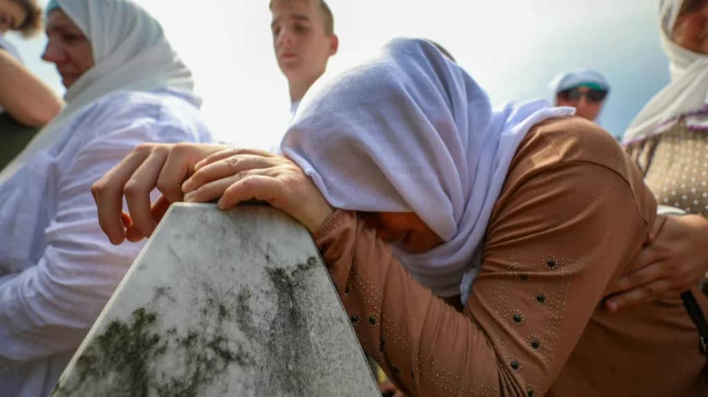 A woman at the burial site of the Srebrenica massacre victims, 11 July 2021. Photo: Elman Omic / Anadolu Agency / Getty Images