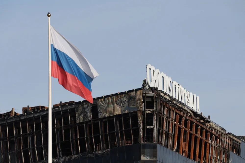 A Russian flag flutters over Crocus City Hall, 21 March 2025. Photo: EPA-EFE/MAXIM SHIPENKOV