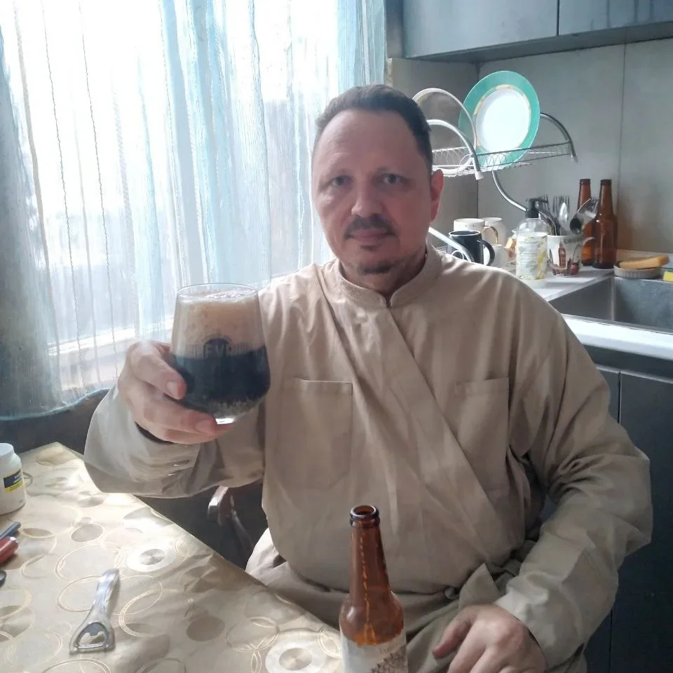 Father Vadim with a beer he brewed himself. Photo: personal archive
