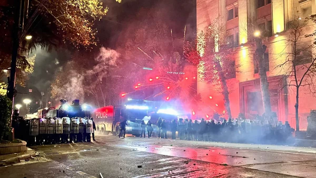 Fireworks explode from behind riot police line in Tbilisi, Georgia, on 30 November. Photo: Nicholas Pearce for Novaya Gazeta Europe