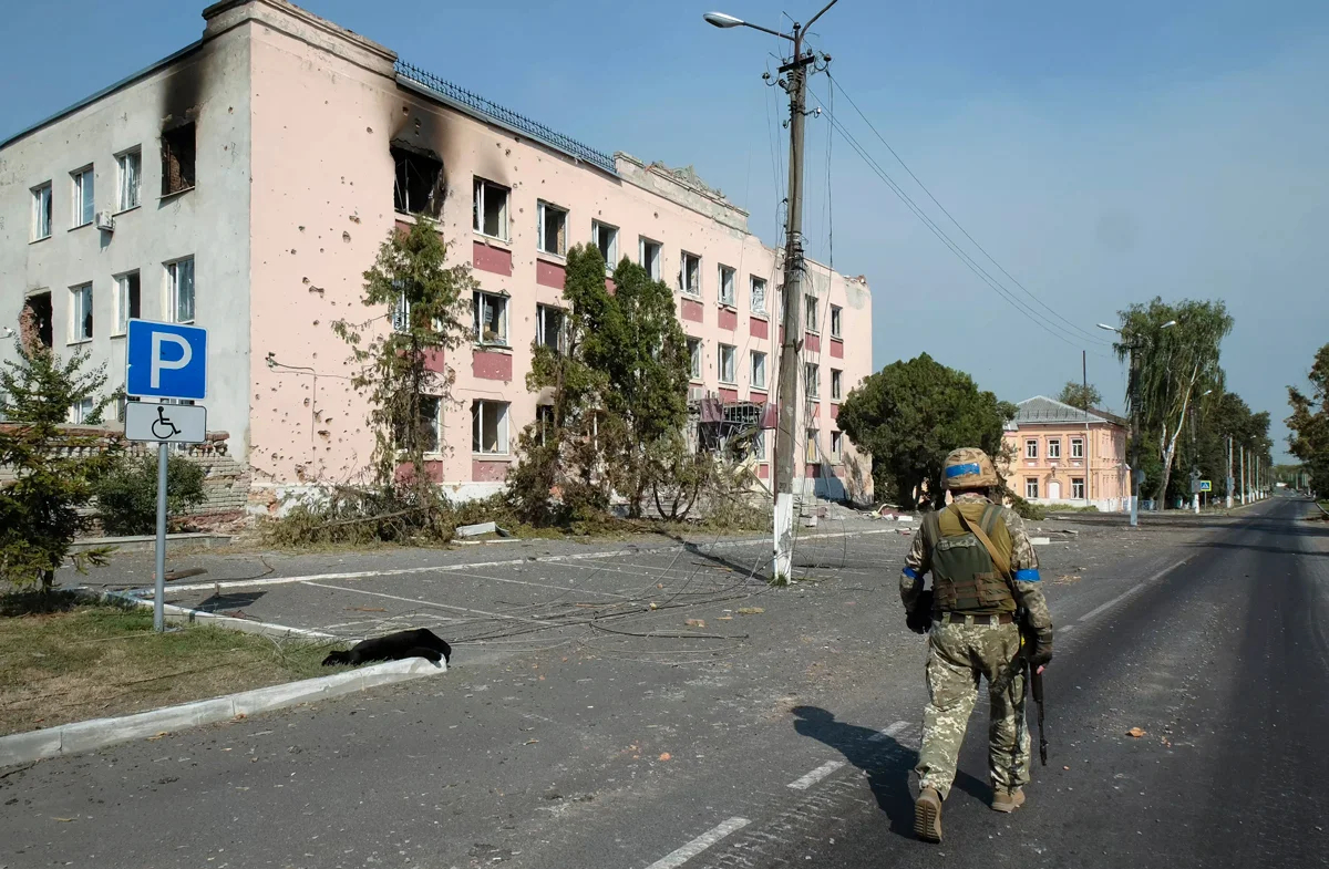 Украинский военнослужащий на фоне поврежденных зданий в центре Суджи, Курская область, 21 августа 2024 года. Фото: EPA-EFE